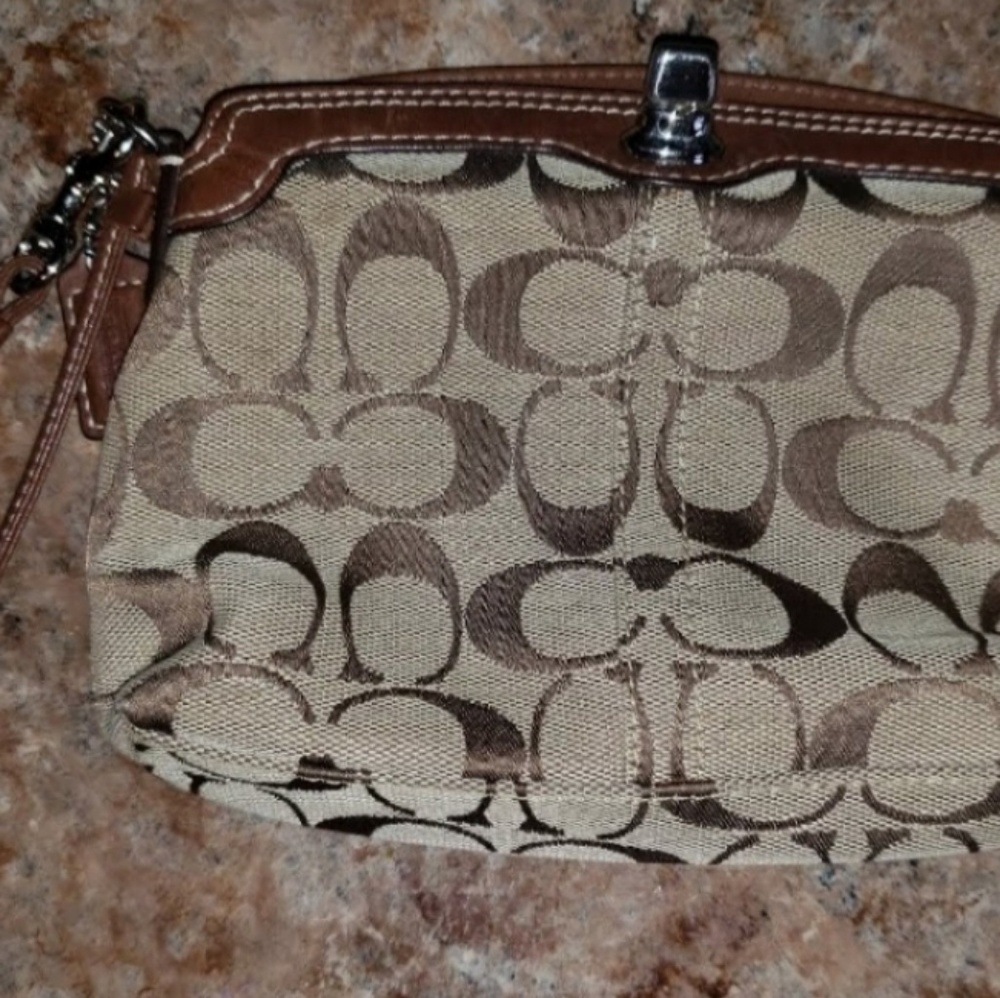 Brown signature Coach C wristlet with toggle